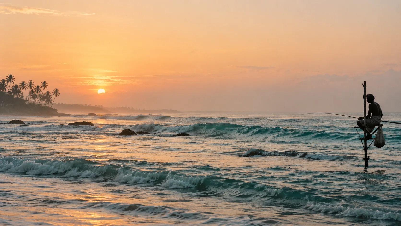A stilt fisherman watches the sun rise over the southern Sri Lankan coast